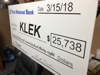 Image of the oversize check presented to KLEK by First National Bank for $25,738. 